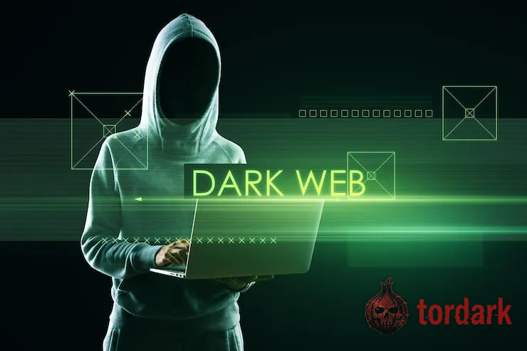 A hooded figure at a laptop beside the glowing green words 'dark web' and abstract interface lines